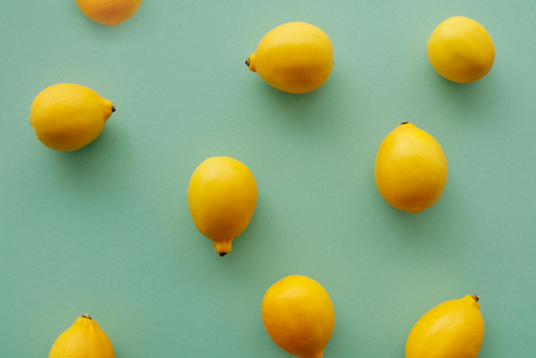 Bright yellow lemons arranged on a pastel background, representing the refreshing intensity of Lemon vibrator sensation